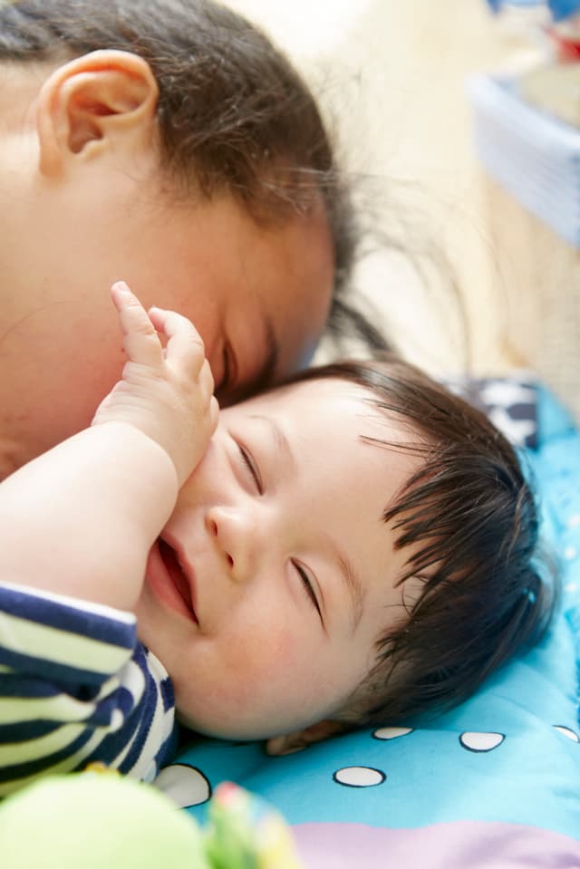 Mother kissing young baby