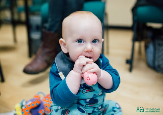 Baby chewing a toy
