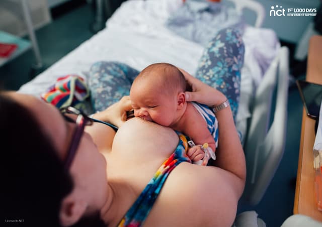 Image shows a person lying down breastfeeding a baby